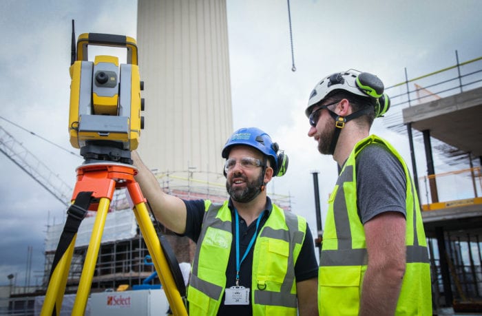 Surveyors using a robotic total station for hire
