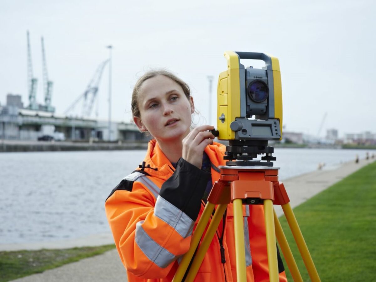 woman using mechanical total station