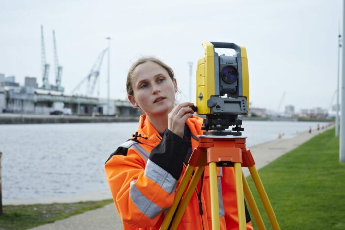 woman using mechanical total station